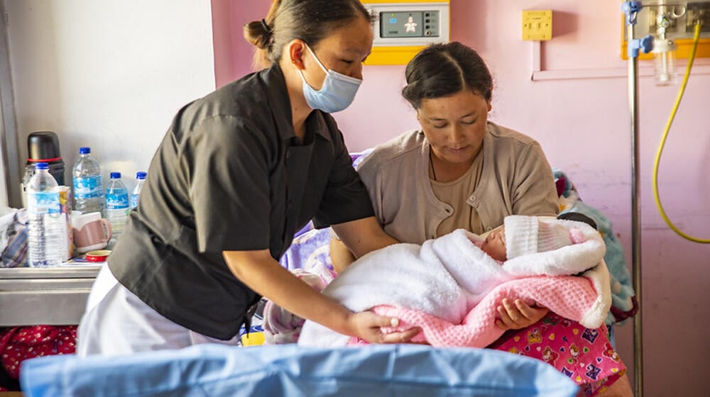 Midwife assisting mother